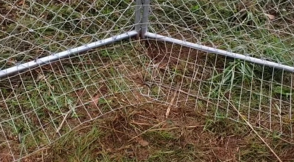 place the ground wire against the inside of the fence